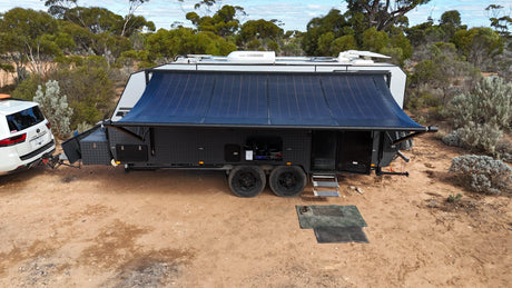 Caravan with the Luxury Awnings Flexible Solar Awning rolled out for shade at an outback camping spot